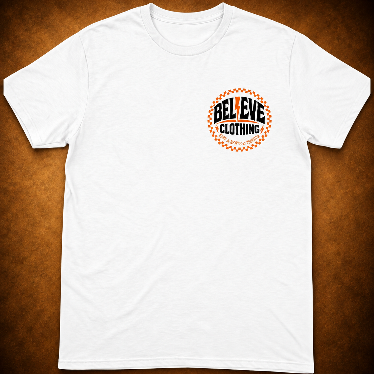 BEL13VE Surf Skate white tee front with 3.5 inch left chest print on warm brown background