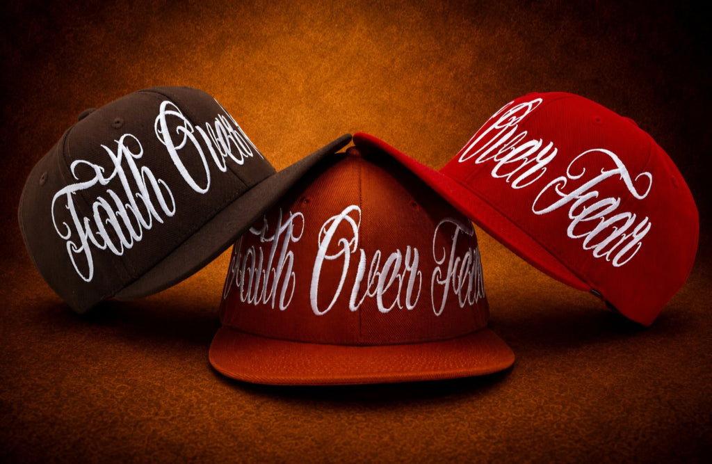 Faith Over Fear embroidered hats in burnt orange, chocolate brown, and red