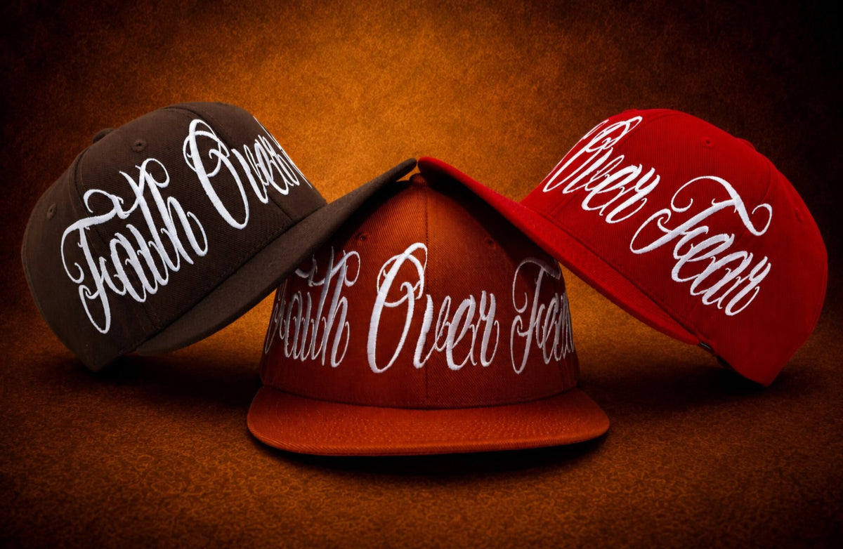 Faith Over Fear embroidered hats in burnt orange, chocolate brown, and red